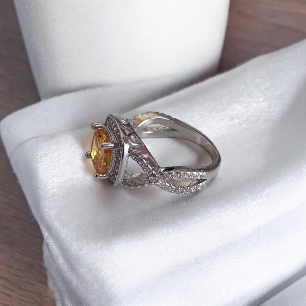 Omayra Boutique Paris ring featuring a yellow cubic zirconia stone with a silver twisted band and pavé accents.