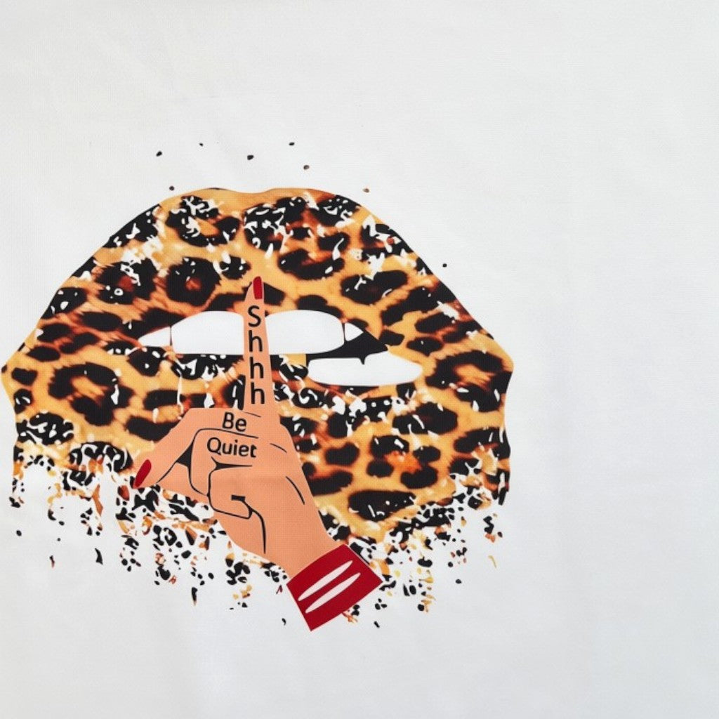 Omayra Boutique white t-shirt with a leopard print lips graphic and a hushing hand gesture design.