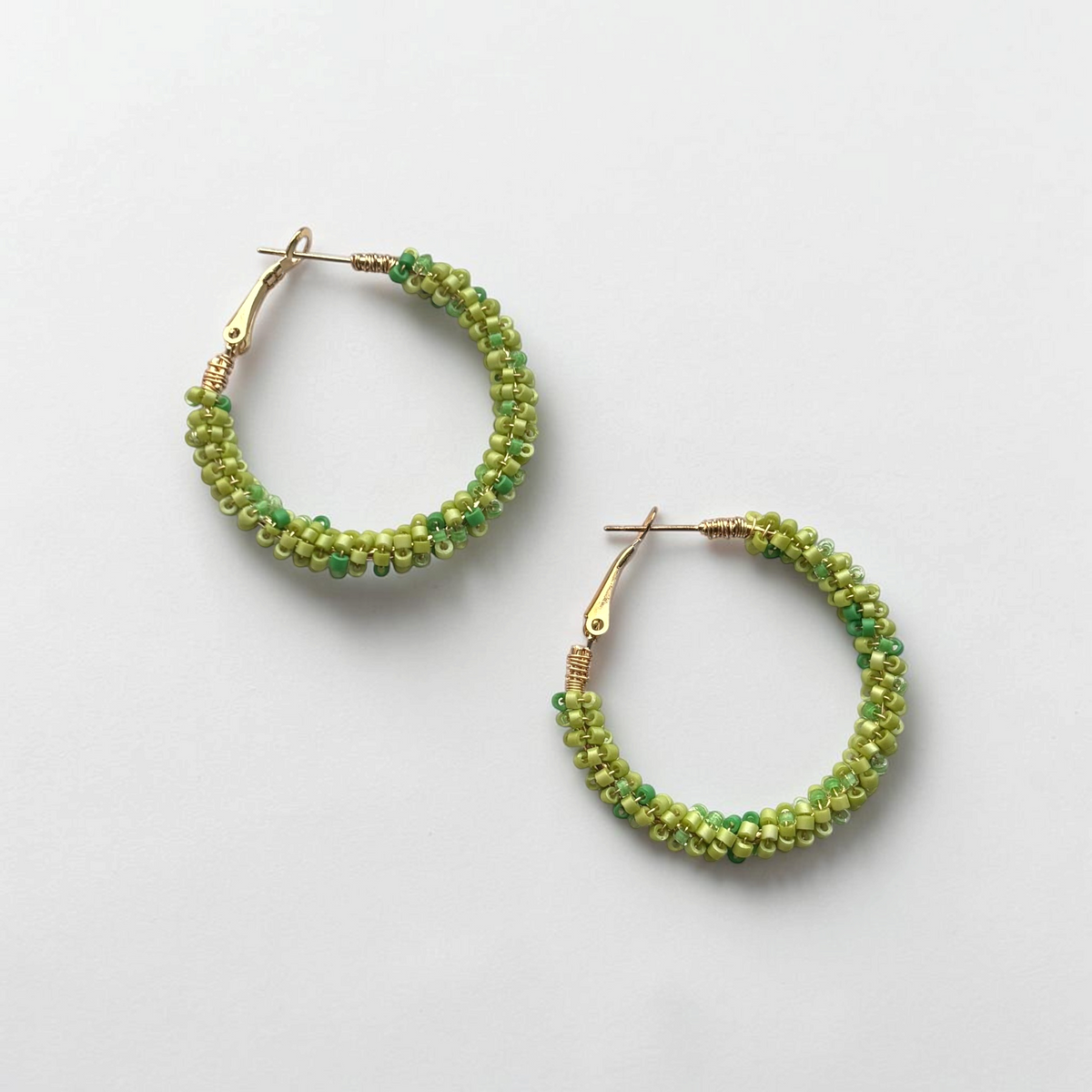 Omayra Boutique Lucky Green hoop earrings featuring vibrant green beaded detail on lightweight zinc alloy frames.