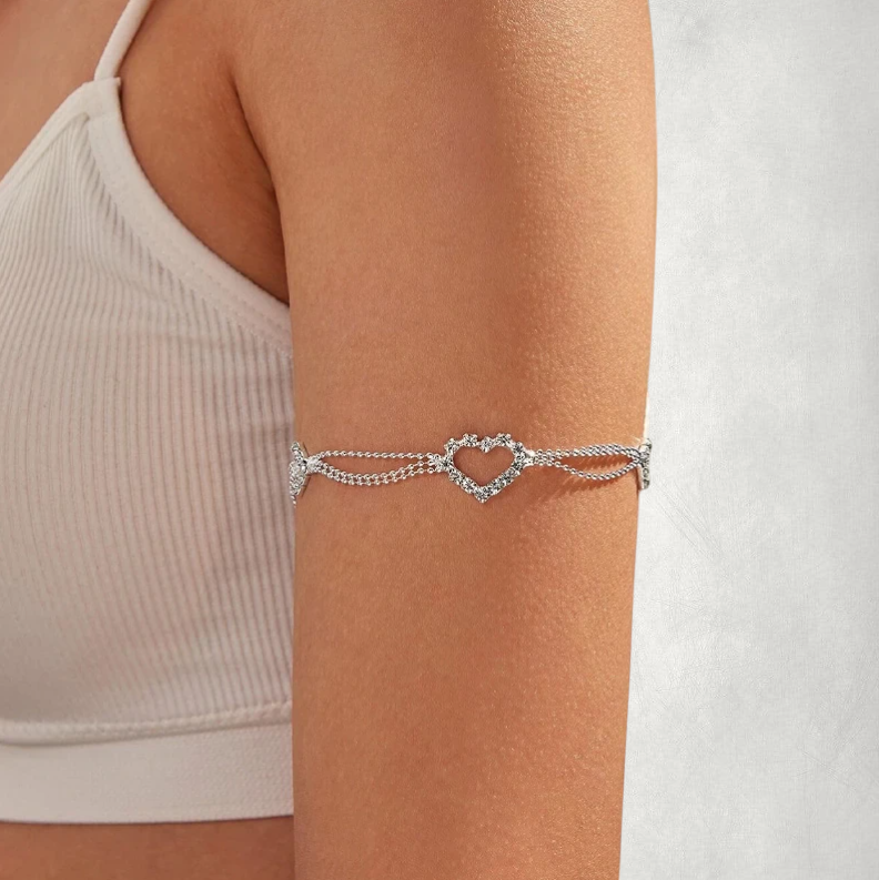 Omayra Boutique silver arm heart adjustable chain bracelet worn on a woman's upper arm with a delicate heart pendant.