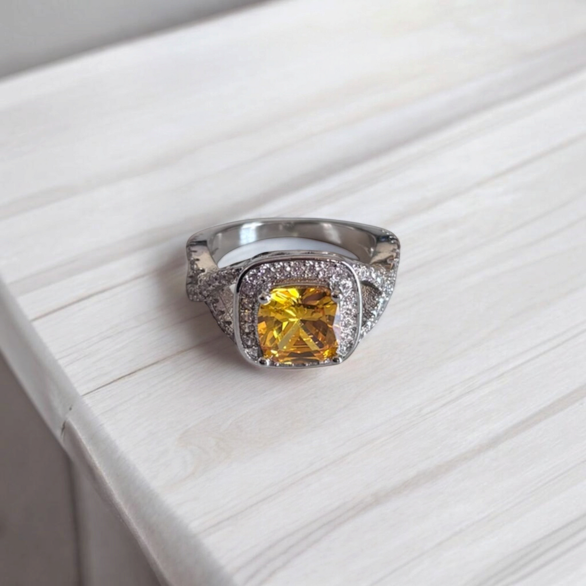Omayra Boutique Paris ring featuring a cushion-cut yellow cubic zirconia stone with pavé accents on a silver band.