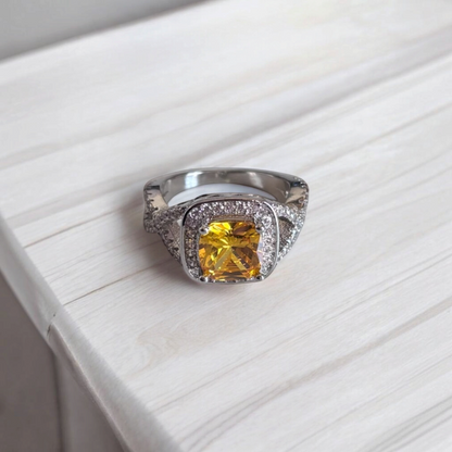 Omayra Boutique Paris ring featuring a cushion-cut yellow cubic zirconia stone with pavé accents on a silver band.