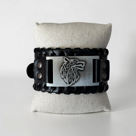 Omayra Boutique men's black leather cuff bracelet featuring a silver-toned metal plate with a Celtic wolf design.