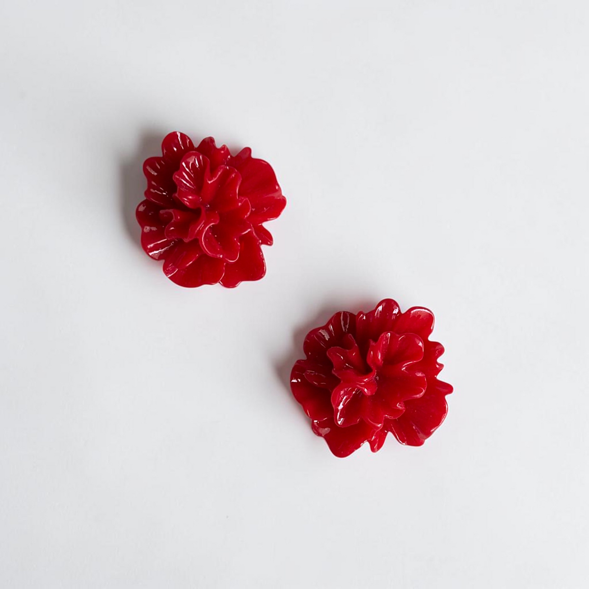 Omayra Boutique red floral stud earrings crafted from lightweight zinc alloy with a vibrant glossy finish.