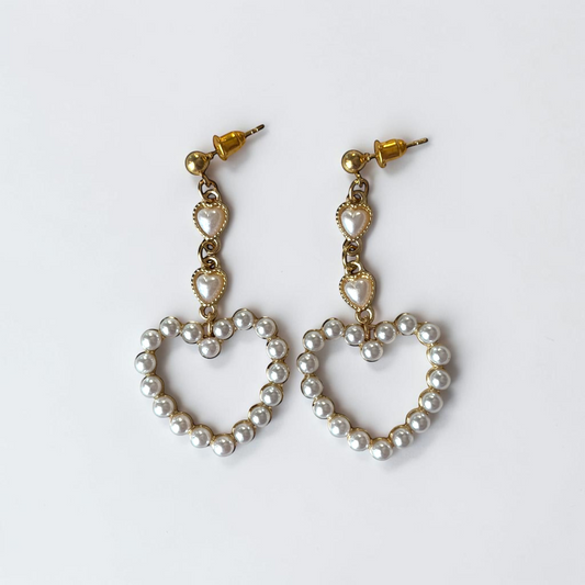 Omayra Boutique long heart-shaped drop earrings featuring white pearls and gold-tone copper accents.