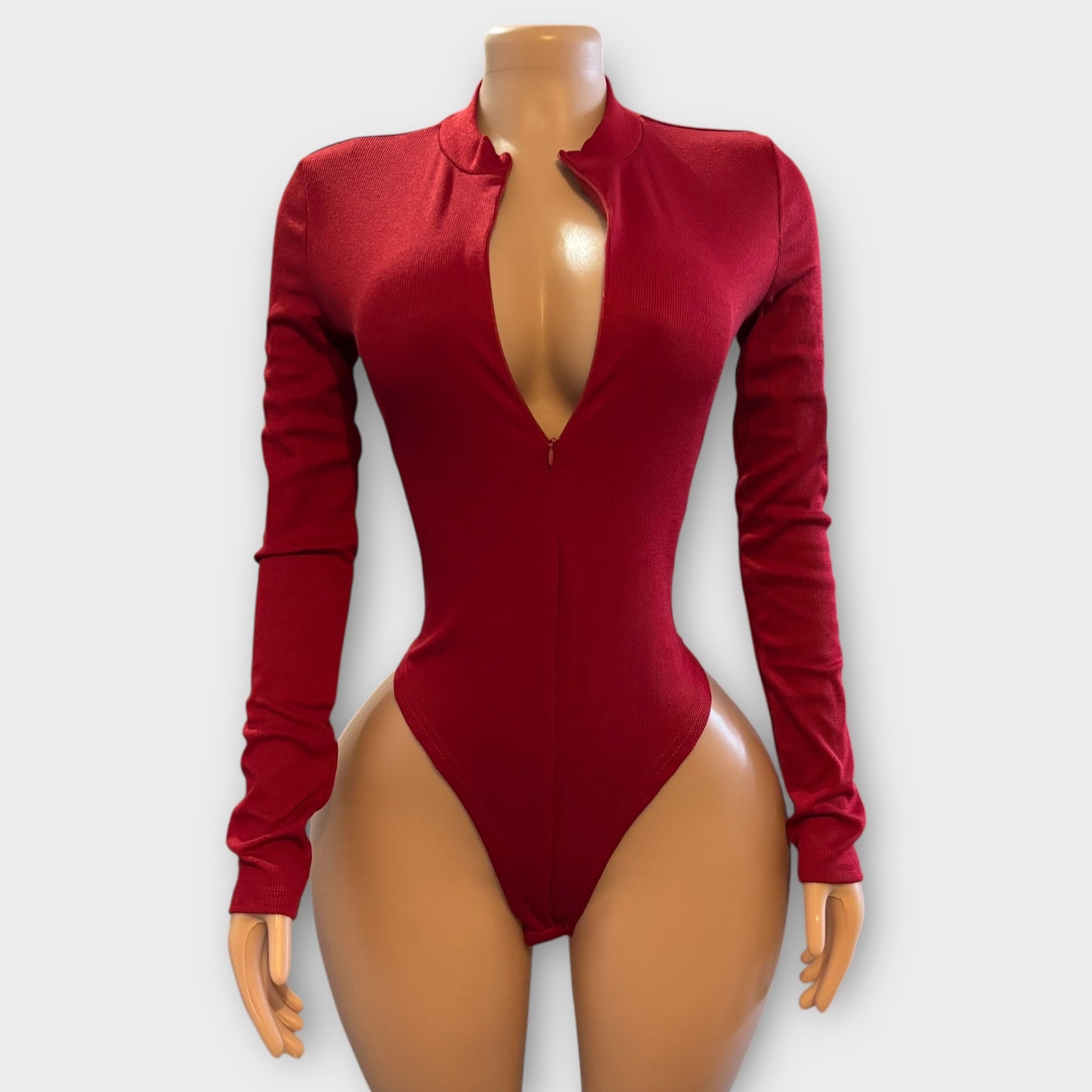 Body de mujer con cremallera en la espalda y manga larga