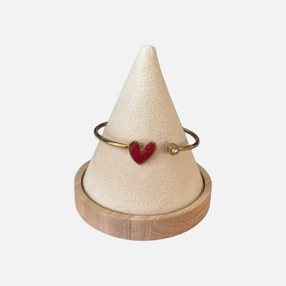 Omayra Boutique dark pink heart cuff bracelet in stainless steel with a sparkling gem on a beige display cone