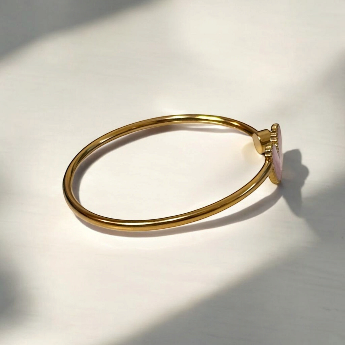 Omayra Boutique light pink heart cuff bracelet in gold-tone stainless steel with a sparkling gem accent