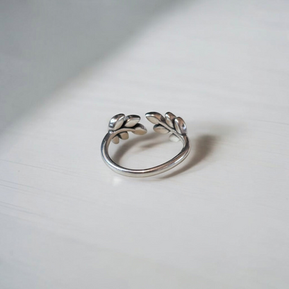 Omayra Boutique 925 sterling silver adjustable ring with a delicate leaf design on a white surface.