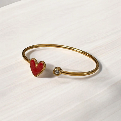 Omayra Boutique gold stainless steel cuff bracelet with a dark pink heart charm and a sparkling crystal accent.