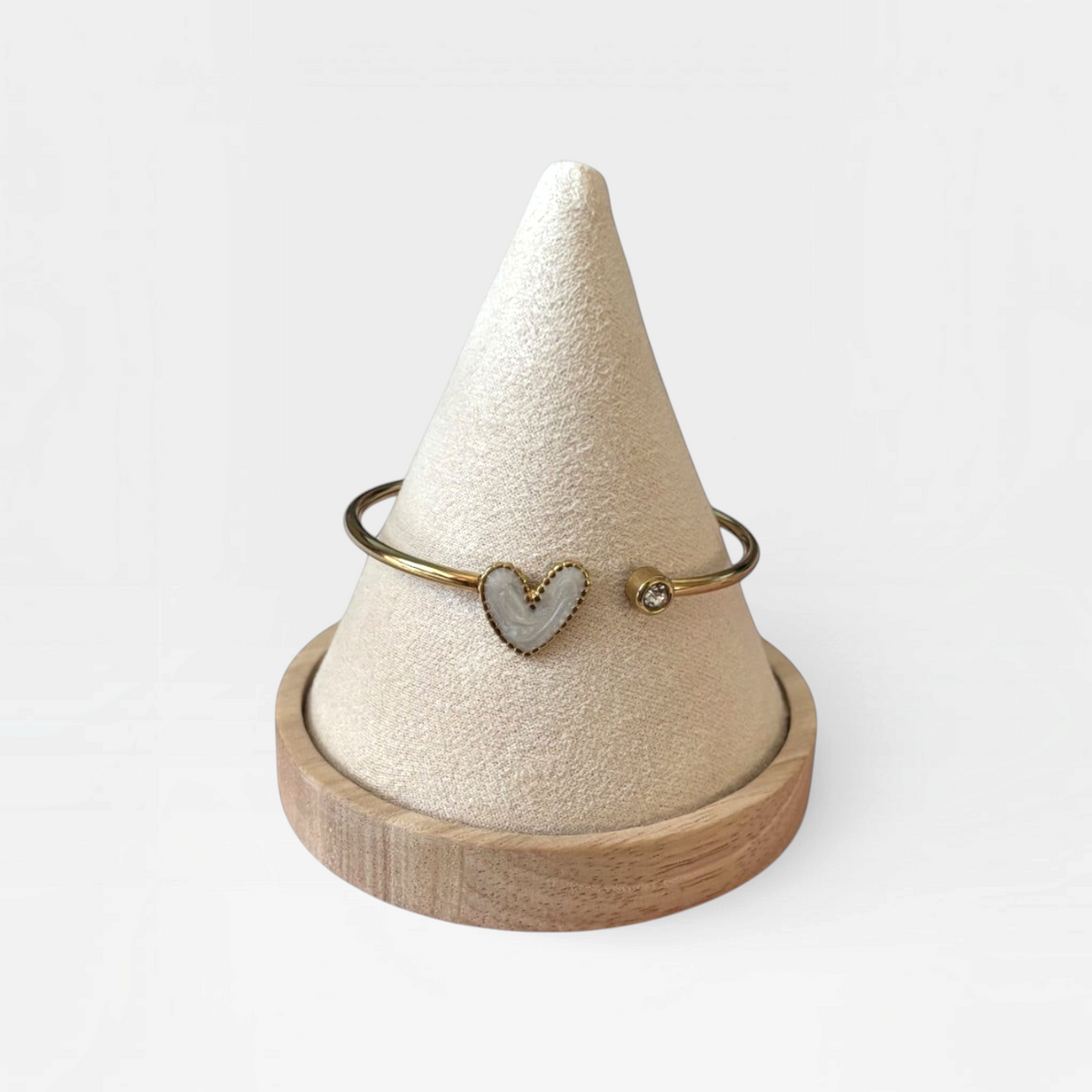 Omayra Boutique gold-tone stainless steel cuff bracelet with a white heart charm and a small sparkling gem.