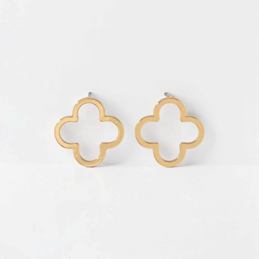 Omayra Boutique gold stainless steel flower stud earrings with a minimalist open clover design on a white surface.