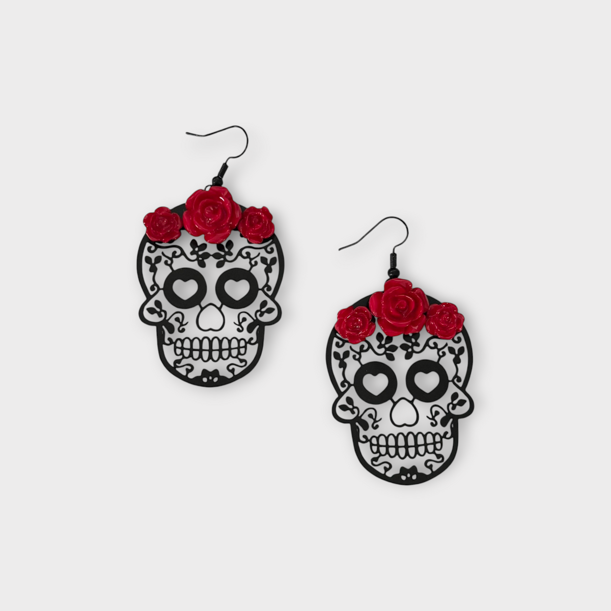Omayra Boutique red rose and black skull drop earrings with intricate filigree detail on a white background.