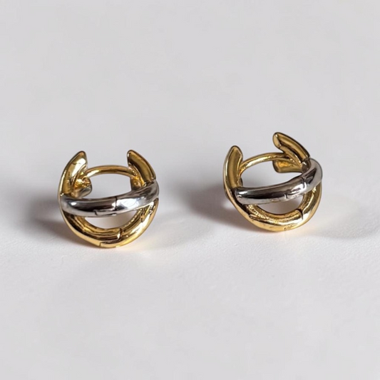 Omayra Boutique small copper stud earrings featuring a two-tone gold and silver cross-shaped color block design.