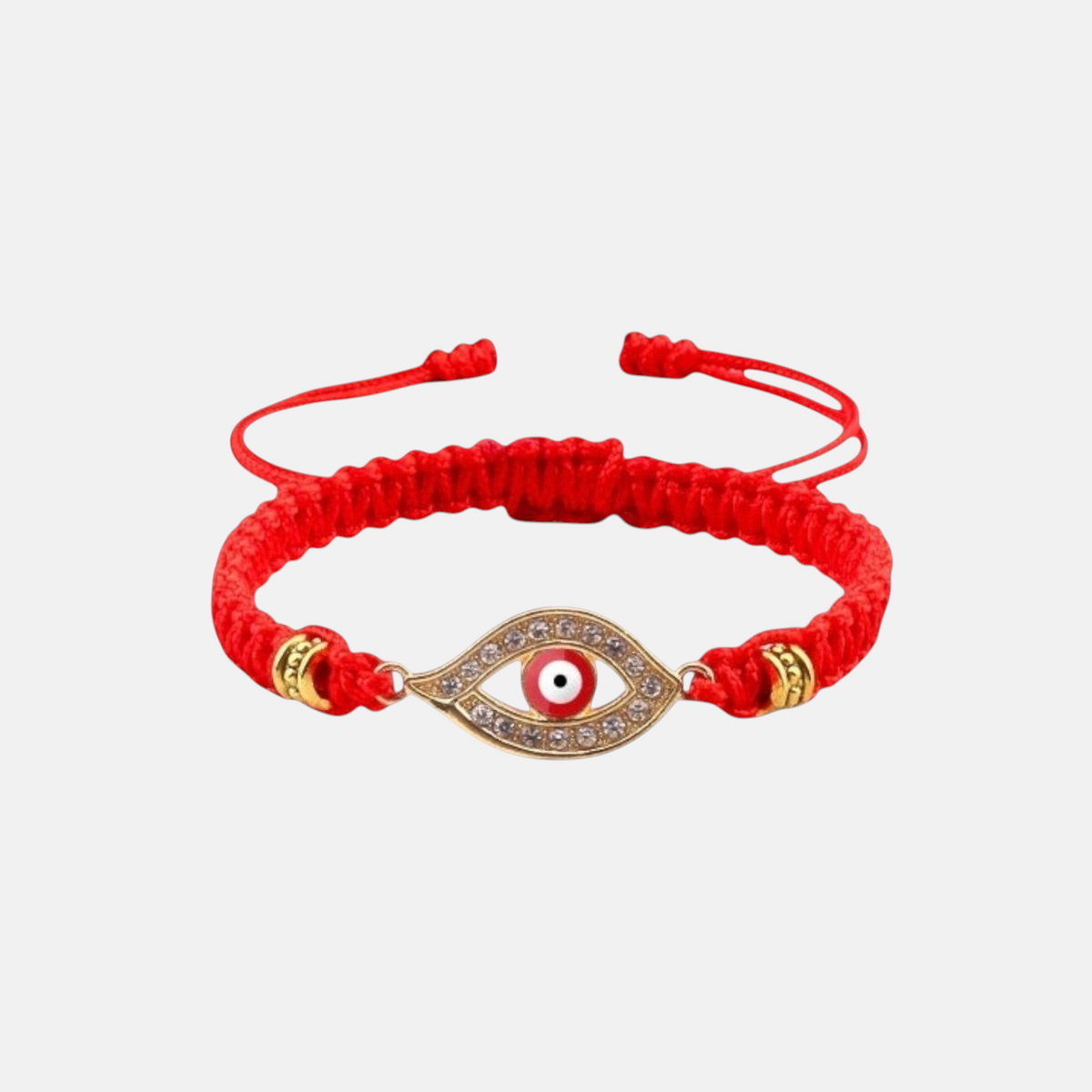 Omayra Boutique handmade red cord evil eye bracelet with gold-tone crystal charm and adjustable sliding knot closure.