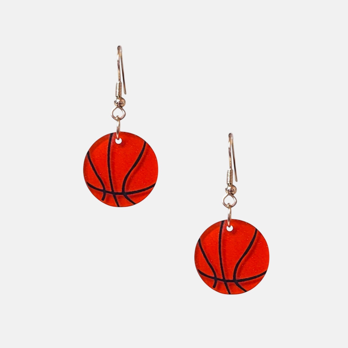Omayra Boutique small basketball acrylic drop earrings with fish hook closure.