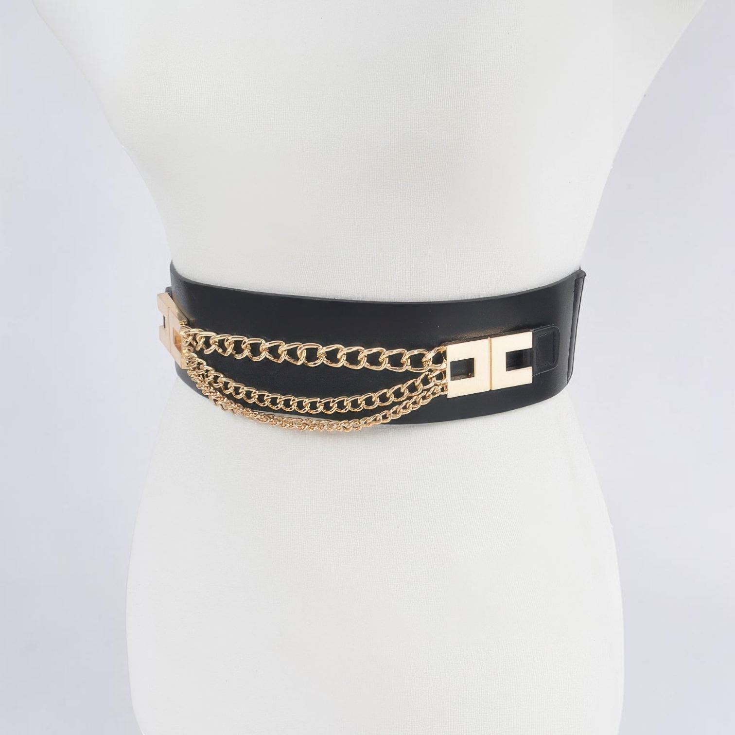 Omayra Boutique black elastic waist belt featuring gold multi-layered chain details and a metallic clasp closure.