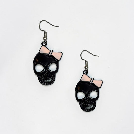 Omayra Boutique black skull earrings with pink bows, 2-inch alloy dangle earrings with a cute and spooky design.