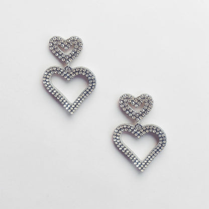 Omayra Boutique double heart drop earrings in silver-tone zinc alloy with sparkling crystal stones.