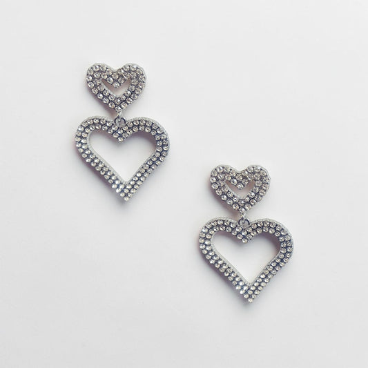 Omayra Boutique double heart drop earrings in silver-tone zinc alloy with sparkling crystal stones.