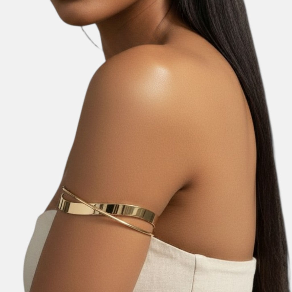 Omayra Boutique polished gold-tone minimalist wrap arm cuff worn by a woman with long dark hair
