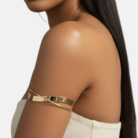 Omayra Boutique polished gold-tone minimalist wrap arm cuff worn by a woman with long dark hair