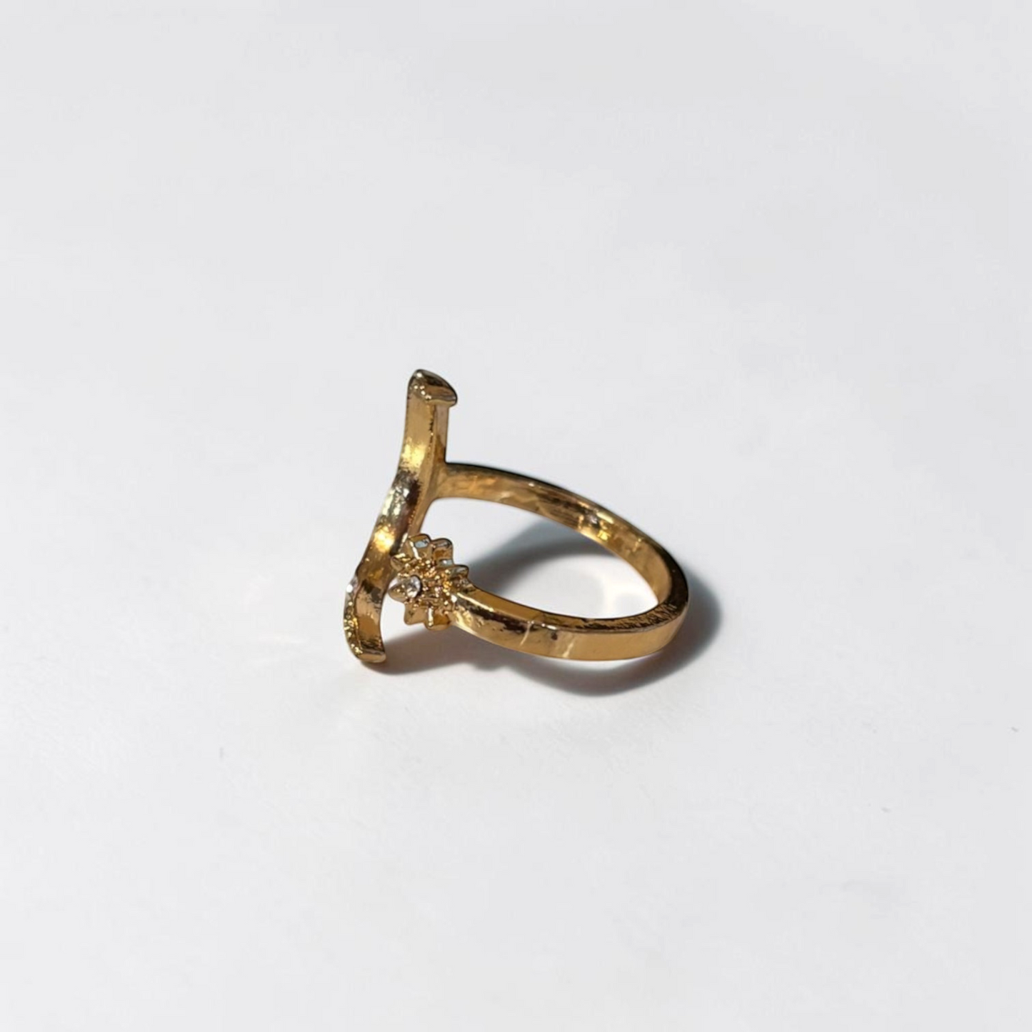 Omayra Boutique gold-tone adjustable open finger ring featuring a moon and star design with delicate crystal accents.