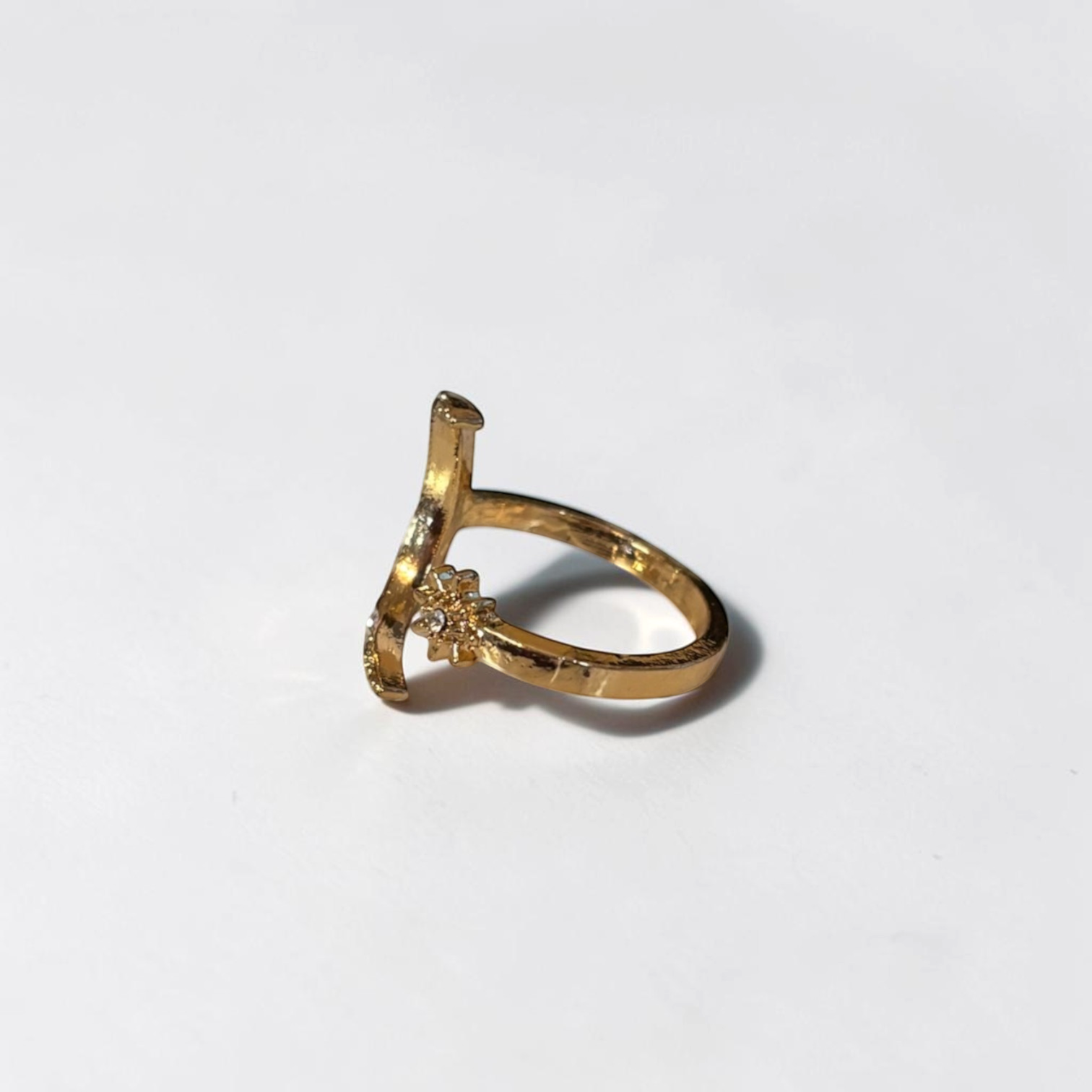 Omayra Boutique gold-tone adjustable open finger ring featuring a moon and star design with delicate crystal accents.