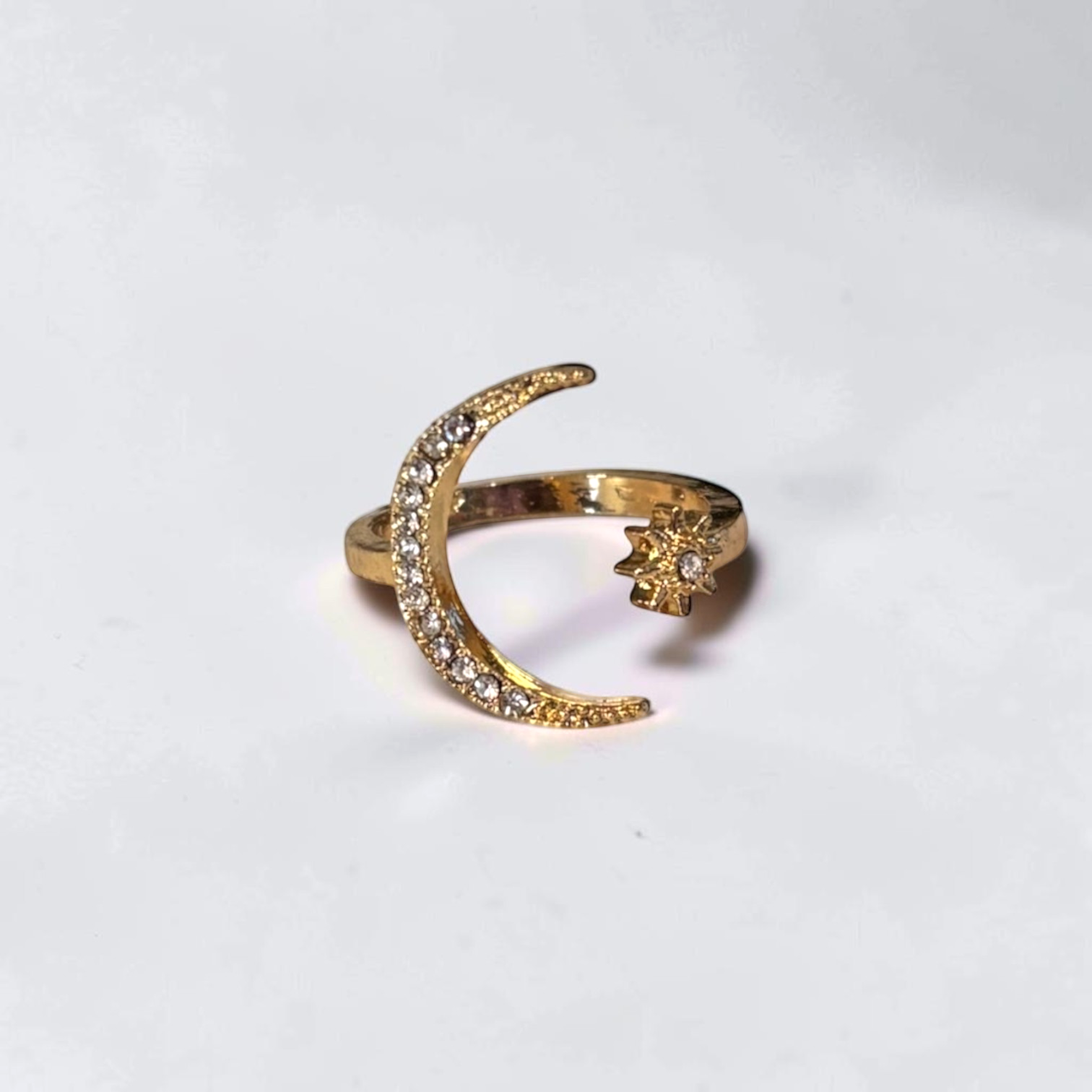Omayra Boutique gold-tone adjustable open finger ring featuring a crystal-studded crescent moon and star design.
