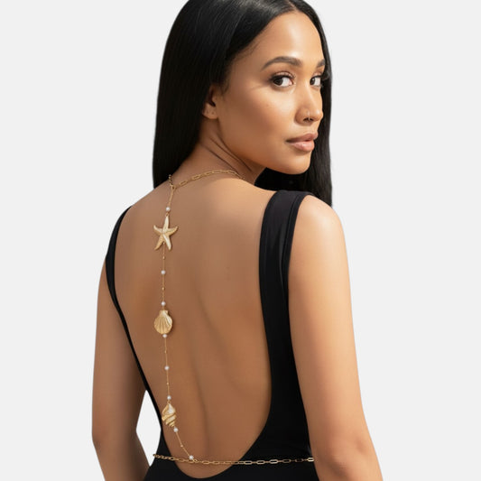 Omayra Boutique gold-tone back body chain featuring starfish, seashell charms, and faux pearls on a model