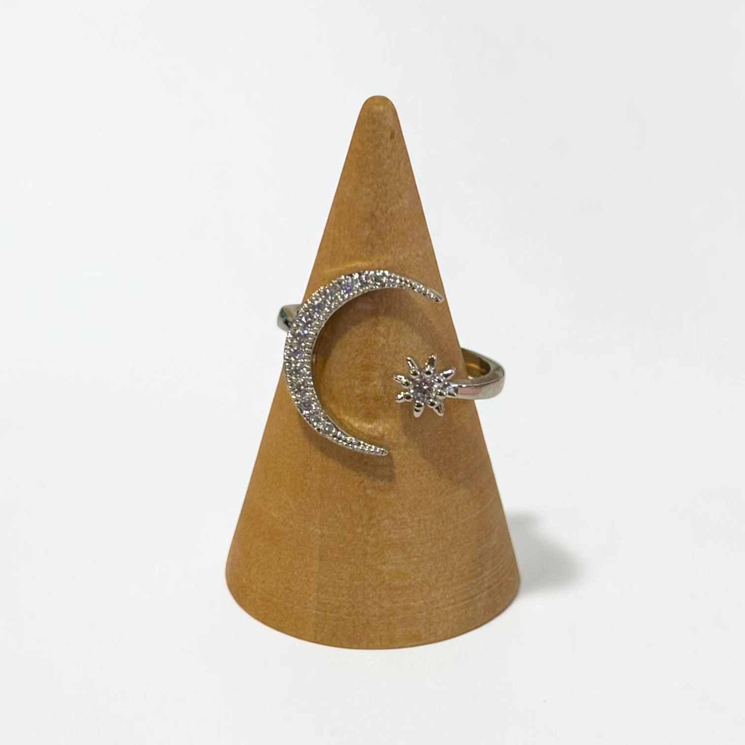 Omayra Boutique silver adjustable ring featuring a crystal-encrusted crescent moon and star design on a display cone.