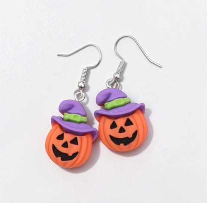 Omayra Boutique Halloween dangle earrings featuring orange jack-o-lantern pumpkins with purple witch hats on hooks.