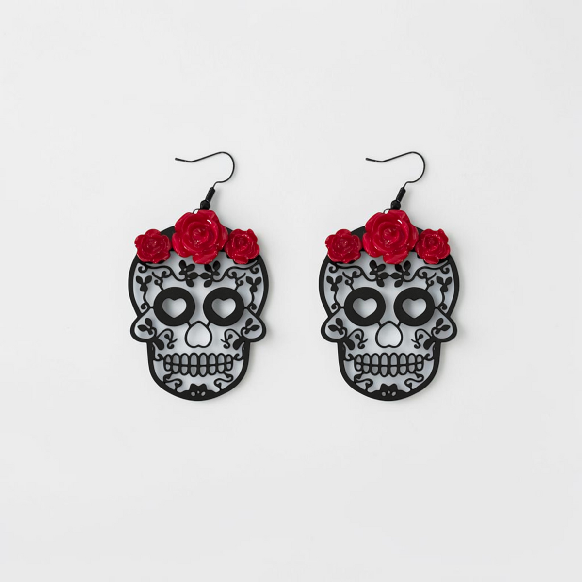 Omayra Boutique drop earrings featuring black skull heads with intricate filigree and vibrant red rose accents.