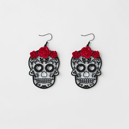 Omayra Boutique drop earrings featuring black skull heads with intricate filigree and vibrant red rose accents.