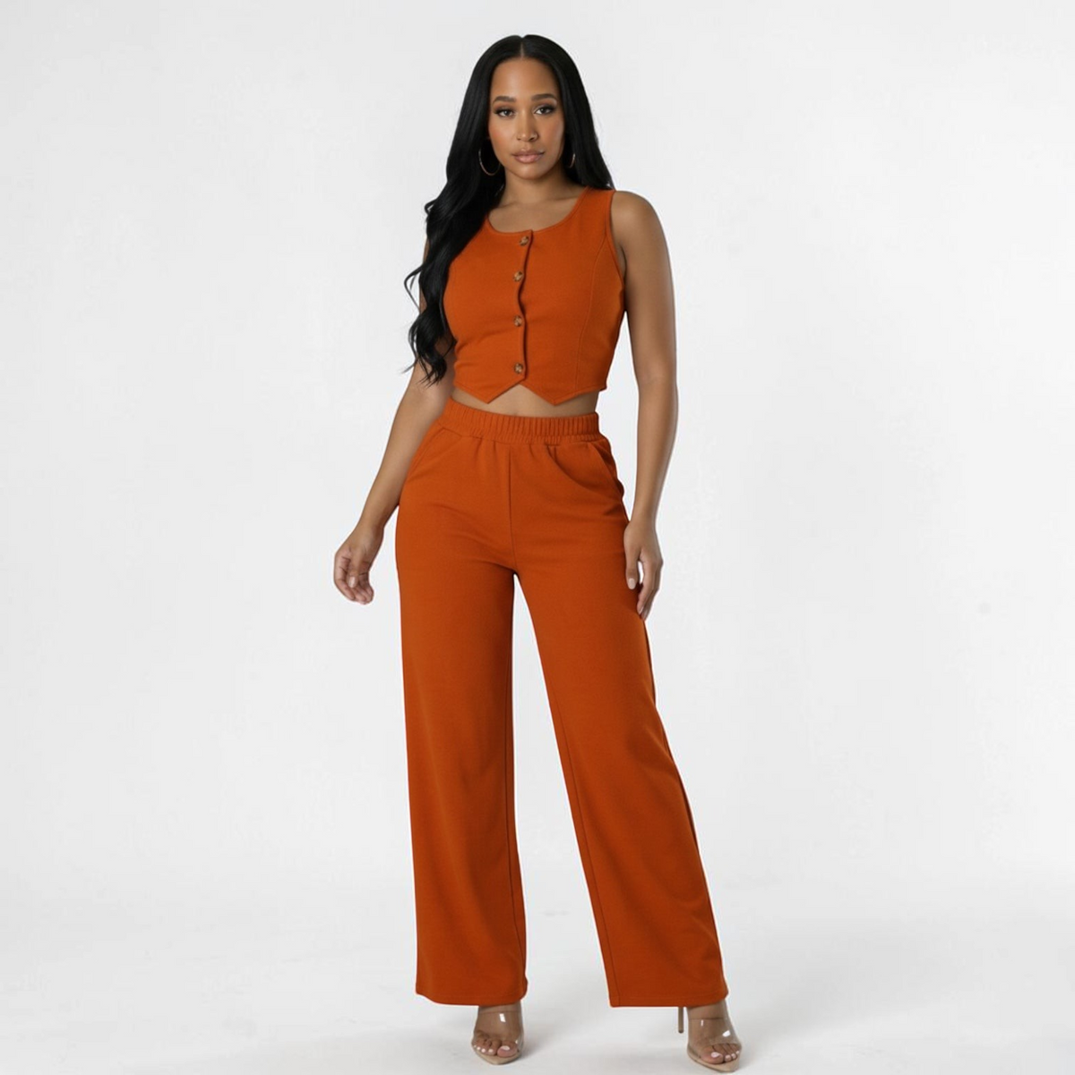 Model wearing an Omayra Boutique rust two-piece set with a button-front scoop neck vest and wide-leg trousers.