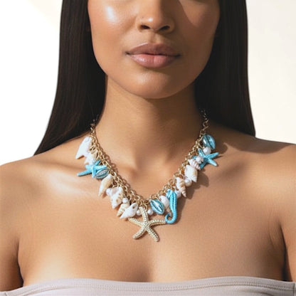 Omayra Boutique multi-charm necklace featuring starfish, seahorse, and seashell charms with pearl accents on a model.