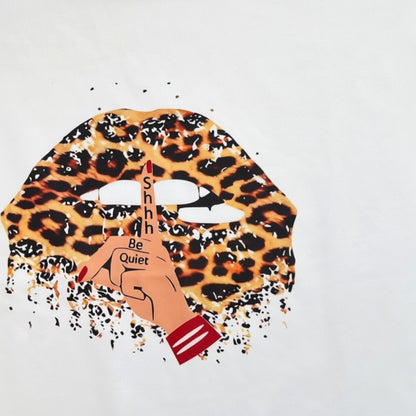 Omayra Boutique white t-shirt with a leopard print lips graphic and a hushing hand gesture design.