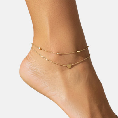 Omayra Boutique double layer gold anklet with heart pendant and bead accents.